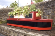 Narrowboat planter in canal basin